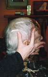 Preparing for template for custom wig by using plastic mold to re-create the forehead