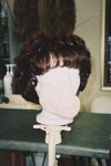 Wig; styled; front view; with skin toned foam that the client can insert in the front of the wig to re-create the shape on her forehead    